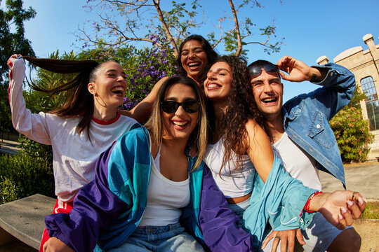 Friends enjoy time in the park under the sun with smiles and lau