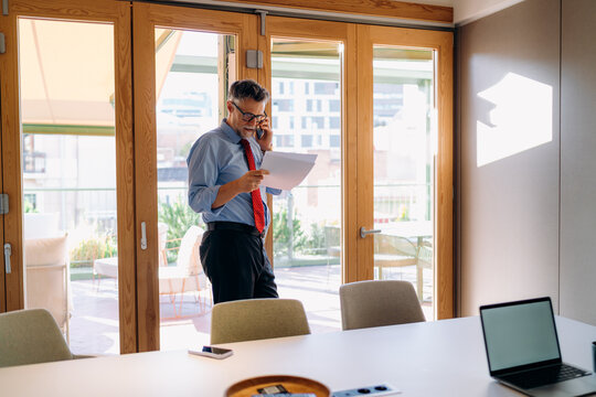 A man talking on a mobile phone in the office