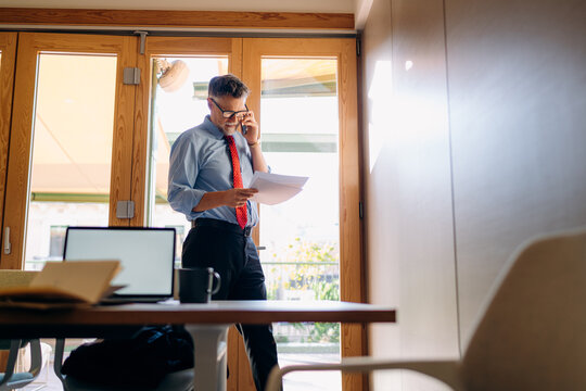 A man talking on a mobile phone in the office