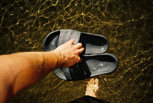 Anonymous person stands in shallow water