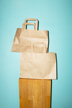 Brown mockup takeaway bags on pedestal with empty space for text/desig