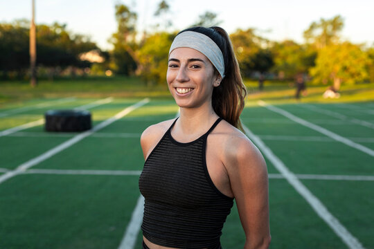 Welcoming athlete standing on outdoor training field