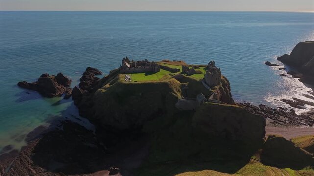 Beautiful cinematic Aerial footage of Dunnottar Castle and Dramatic Cliffs, Stonehaven Scotland &ndash; Historic Medieval Fortress on the North Sea	