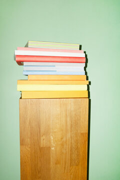 Contemporary book pile on a pedestal in work business office