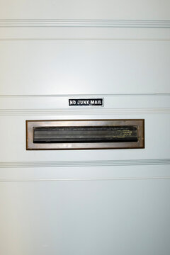 Conceptual image of a door and mailbox with sign "no junk mail"