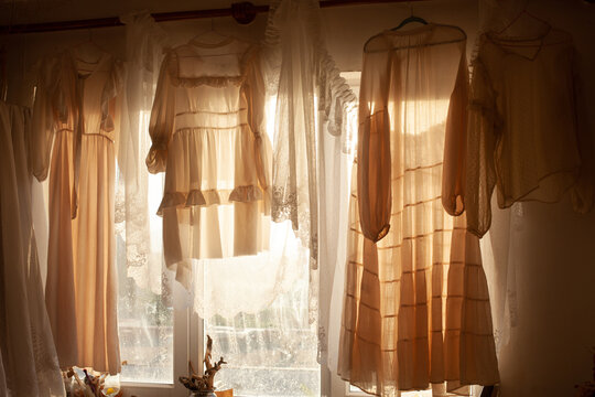 The room with the white dresses in the sunlight 