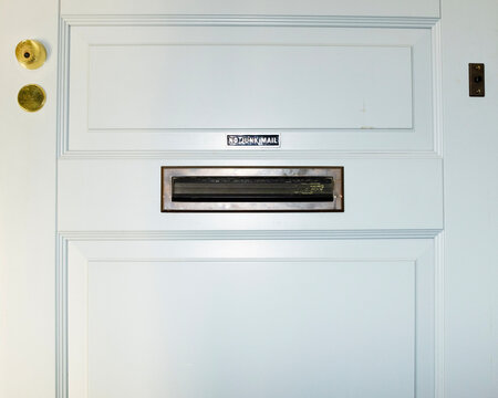 Conceptual image of a door and mailbox with sign "no junk mail"