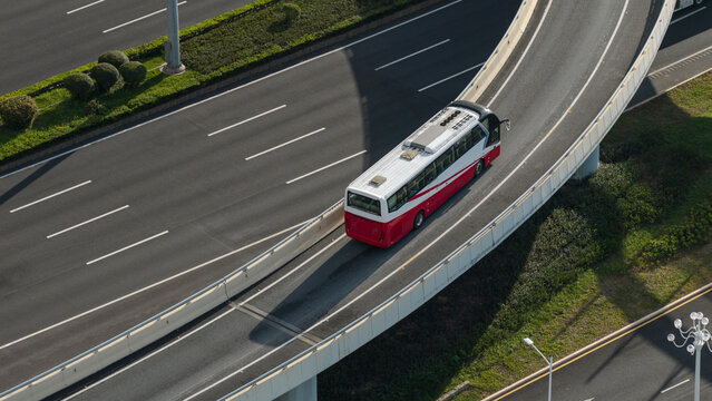  Aerial Shot of Coach Bus Driving on Urban Curved Overpass