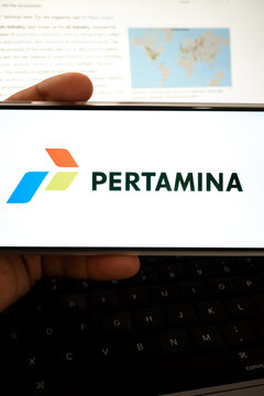 Holding device displaying pertamina logo and company information