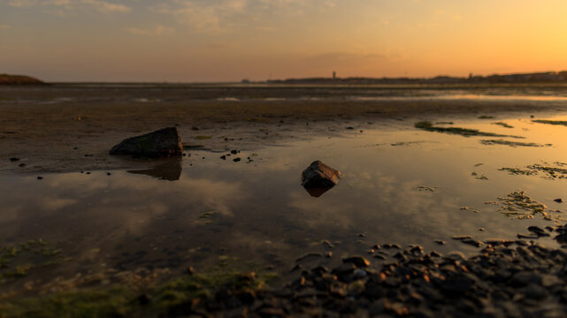 Dreamy image of the harbor of Terschelling at ebb tide during a colorful sunset