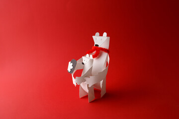Paper polar bear holding polar bear cub on red background. Parent and child relationship, family care and winter holiday concept. Design for greeting card, pos © Elena