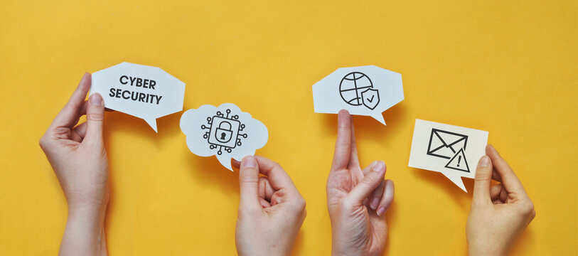Hands Holding Cybersecurity Speech Bubbles With Digital Protection Icons on Yellow Background