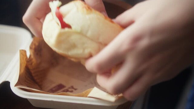 Opening Takeout Box and Taking Out Fresh Homemade Burger. Close-up of hands opening a biodegradable takeout box to reveal a fresh homemade burger, then lifting it out.