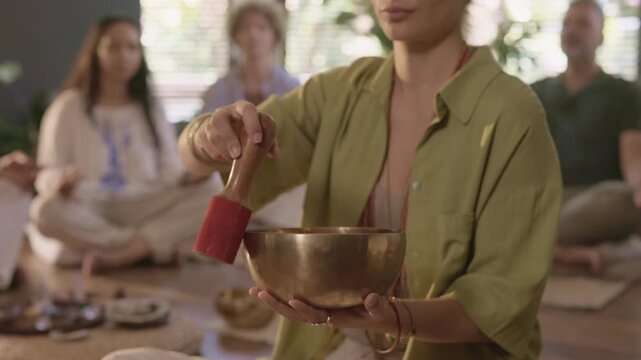 Close up of female hands singing tibetan bowl