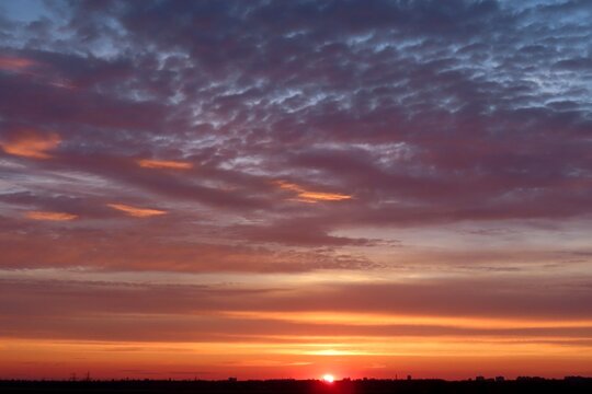 Beautiful sunset background, the sun goes down over the horison
