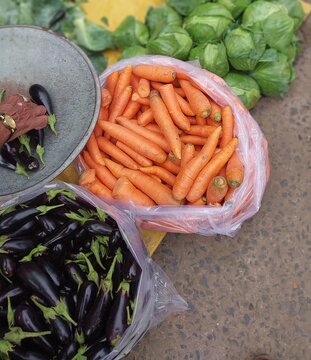 Fresh Carrots Displayed with Seasonal Vegetables at Market