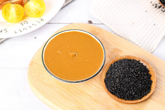 Traditional Chinese Sesame Sauce with Black Sesame Seeds on Wooden Board - Beijing Henan Cuisine Hot Pot Dipping Sauce