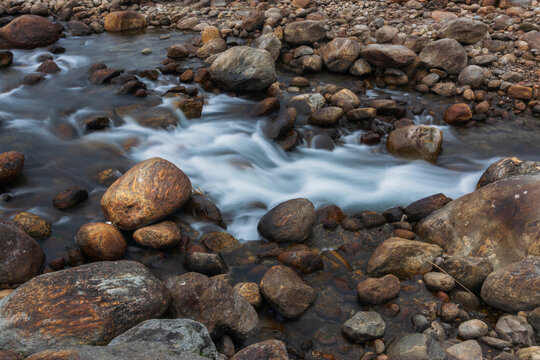 Jaldhaka River and stones at river bed, flowing through India, Bhutan, and Bangladesh. Originating from Kupup Lake in East Sikkim. Joldhaka river, Jhalong - Dooars , north bengal - West Bengal, India.