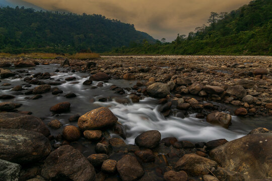 Scenic beauty of Jaldhaka River and stones at river bed, flowing through India, Bhutan, and Bangladesh. Originating from Kupup Lake in East Sikkim. At Jhalong-Dooars, north bengal- West Bengal, India.