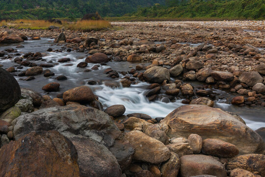 Jaldhaka River and stones at river bed, flowing through India, Bhutan, and Bangladesh. Originating from Kupup Lake in East Sikkim. Joldhaka river, Jhalong - Dooars , north bengal - West Bengal, India.