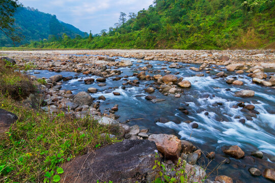 Scenic beauty of Jaldhaka River and stones at river bed, flowing through India, Bhutan, and Bangladesh. Originating from Kupup Lake in East Sikkim. At Jhalong-Dooars, north bengal- West Bengal, India.