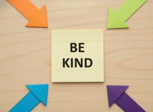 Be Kind Message with Colorful Arrows on Wooden Background
