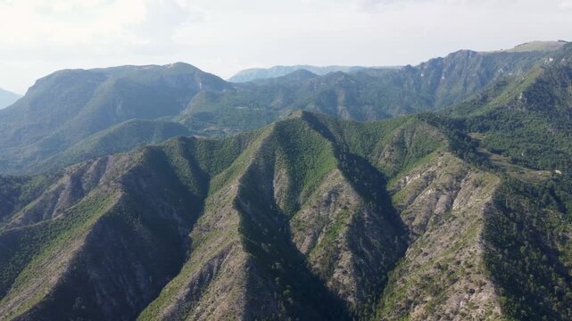 Aerial drone view of high mountains covered in forest. Mountain massif. Mountain range from an aerial perspective. Neretva river canyon, Bosnia and Herzegovina. 