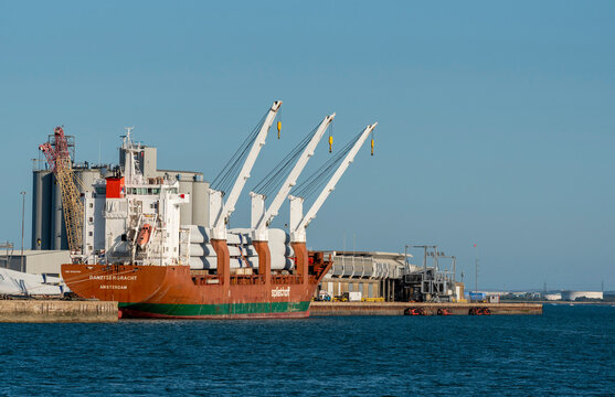 Southampton southern England UK. 26.07.2026. A massive cargo vessel is moored at a port facility, in Southampton its deck laden with components for wind turbines, ready for transport across the sea