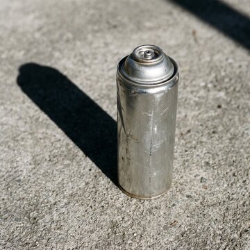 Empty Label‑Free Aerosol Spray Can on Rough Concrete &ndash; 2K Environmental Ozone Awareness Abstract