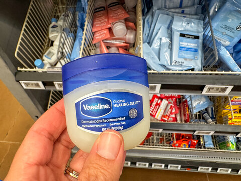 Mesa, Arizona - July 23, 2026: Hand holds a travel size Vaseline healing jelly lotion at a Walmart store