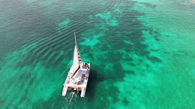 fishing boat in the sea - Catamaran Sailboat with Striped Sail on Caribbean Sea, Aruba