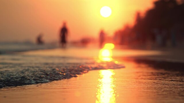 Close-up of gentle sea waves washing onto a sandy beach during golden hour sunset. Beautiful low-angle view with shallow depth of field, Peaceful mood of a summer vacation at the tropical shore.	
หมวด