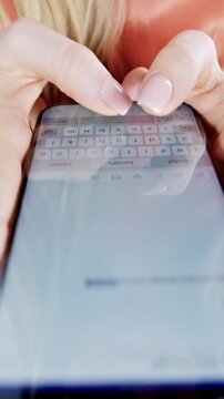 Female hands using smart phone to type or browse in vertical