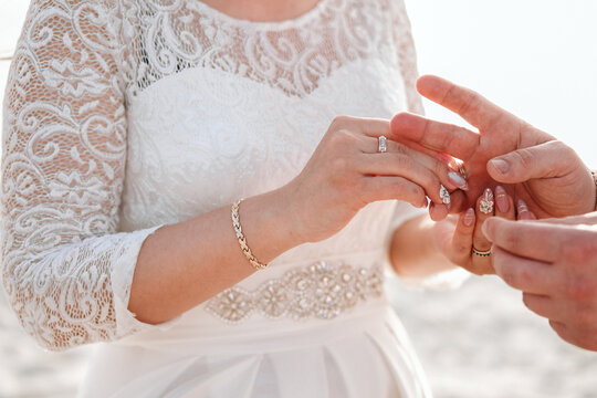 bride and groom hands with rings