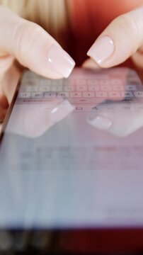 Female hands using smart phone to type or browse in vertical