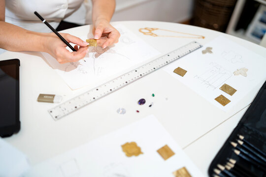 Hands creating custom jewelry, designing handmade crafts and unique accessories