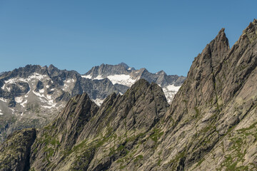 Fototapeta premium Guttannen, Switzerland. Close-up panorama of rugged granite mountain ridges and alpine glaciers viewed from Gelmerseehütte in the Bernese Alps 