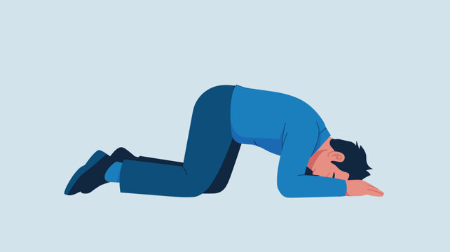 Frustrated man in blue clothes lies on his knees and elbows with head down on the floor expressing deep despair or sadness.