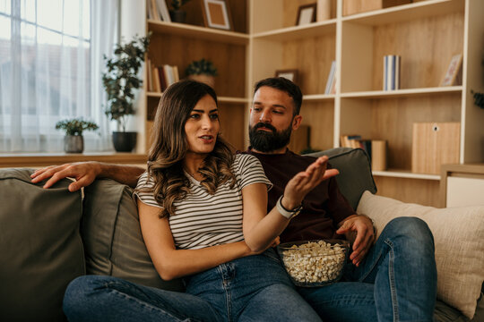 Couple having a serious conversation while relaxing at home