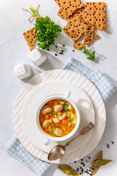 Austrian meatball soup with veggies in a bowl