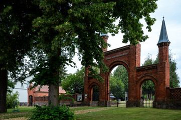 Historic churchyard gate with old trees in Langen, Brandenburg © Jrg