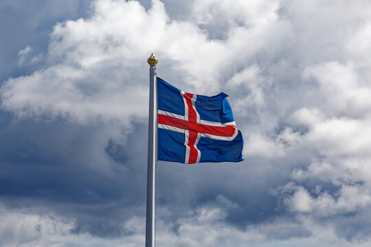 National Flag of Iceland Fluttering Against Cloudy Sky