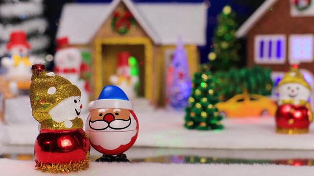 Against the backdrop of a small Christmas village, an unusual Santa Claus comes running to a snowman