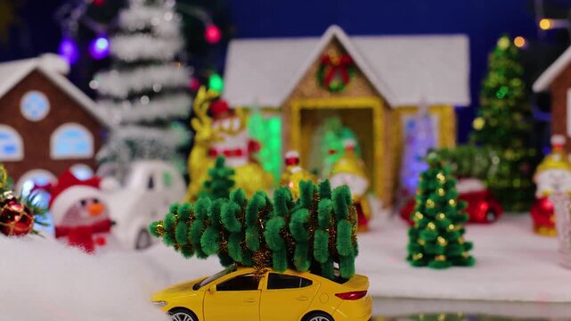 A yellow car drives up to the decorated Christmas town