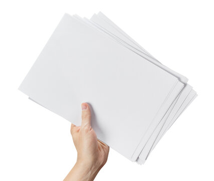 Stack of blank white paper sheets held in hand, isolated on transparent cutout background