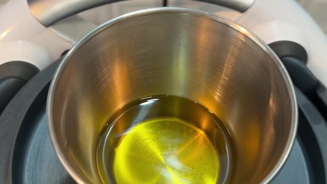 Enjoying the art of making salmorejo with olive oil in a cozy kitchen setting