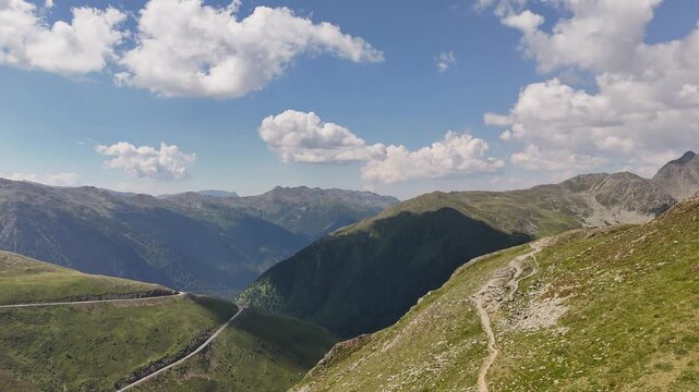 Smooth aerial drone takeoff and forward flight over a lush green alpine valley with a stream near Hochfeiler in the Zillertal Alps.
