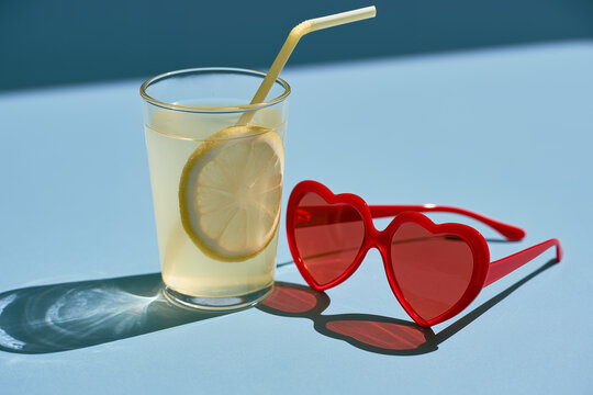 Red sunglasses with lemonade. A summer background with lemonade. 