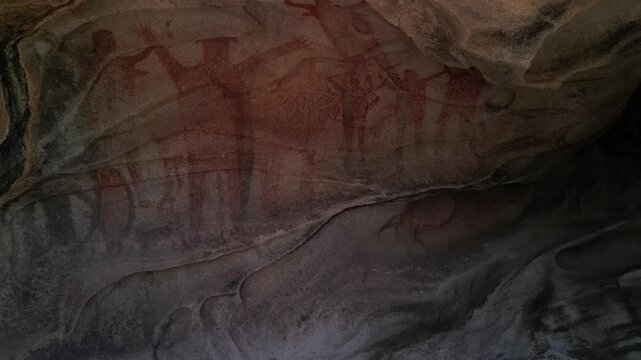Cinematic shot exploring the ancient Great Murals cave paintings on a rock shelter wall in the Sierra de San Francisco, Baja California Sur, revealing prehistoric indigenous rock art
