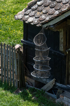 Traditional Wooden Farm Building with Hanging Fish Trap